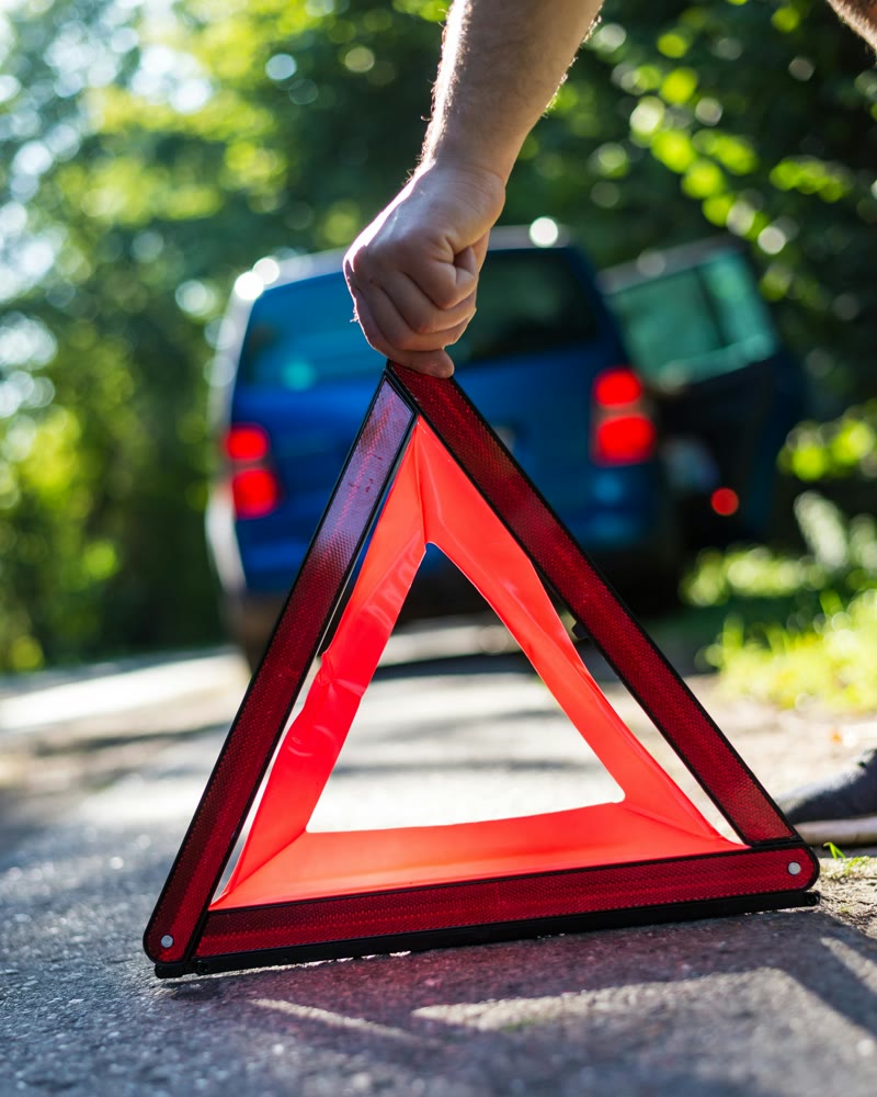 Broken down car with warning triangle